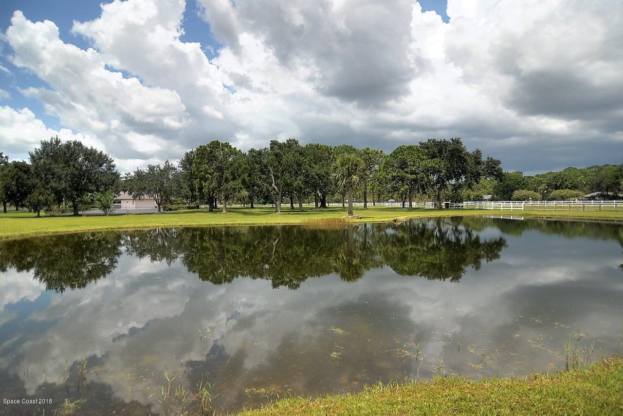 4107 Pinewood Road Melbourne, FL 32934 - Photo 6 of 32 a view of a lake with a big yard