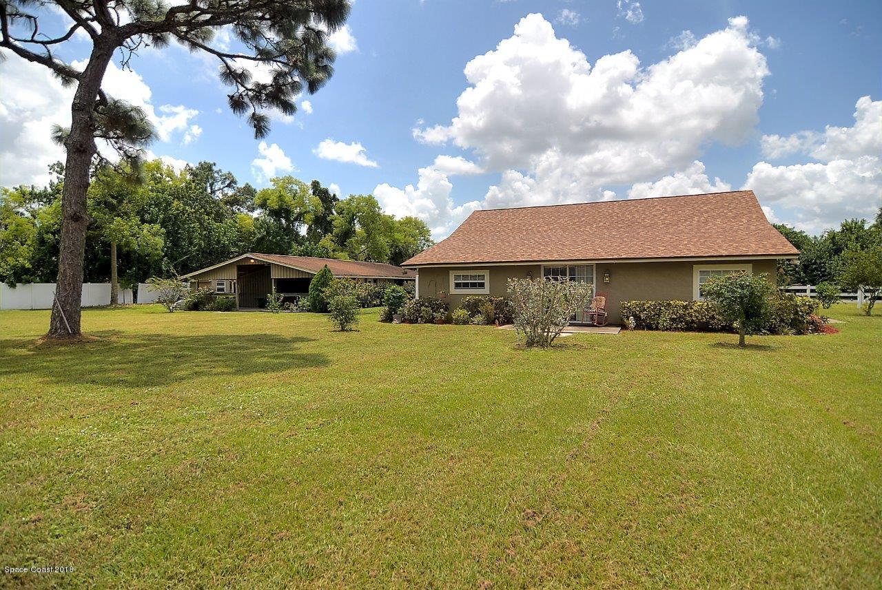 4107 Pinewood Road Melbourne, FL 32934 - Photo 10 of 32 a front view of house with yard and swimming pool