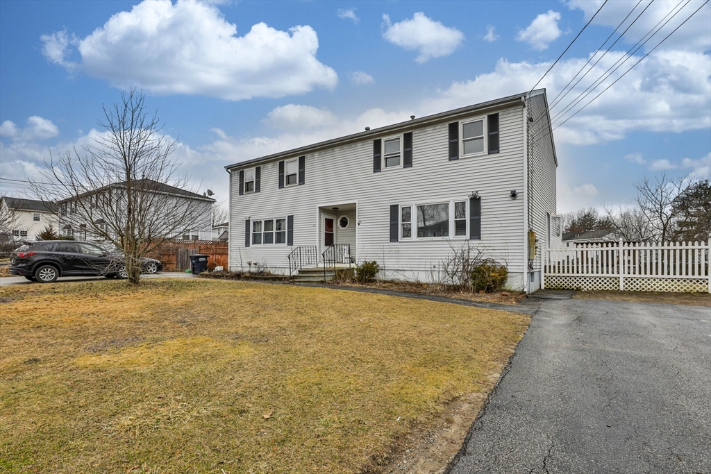 5 Norman Drive, Unit R Derry, NH 03038 - Photo 1 of 28 a front view of a house with a yard