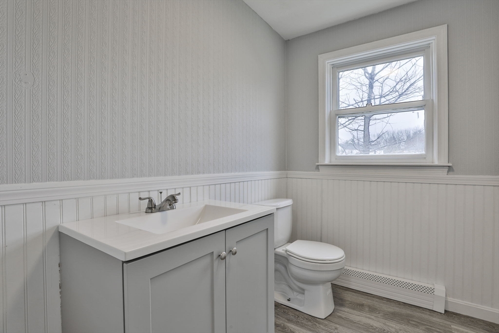 5 Norman Drive, Unit R Derry, NH 03038 - Photo 13 of 28 a bathroom with a toilet sink and mirror