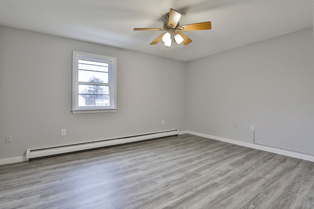5 Norman Drive, Unit R Derry, NH 03038 - Photo 19 of 28 wooden floor in an empty room with a window