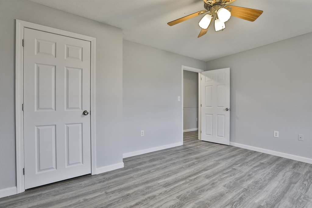 5 Norman Drive, Unit R Derry, NH 03038 - Photo 20 of 28 a view of an empty room with wooden floor