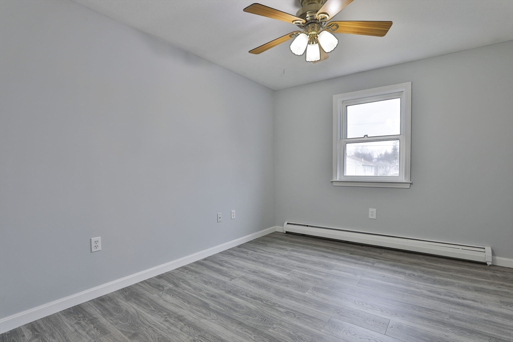5 Norman Drive, Unit R Derry, NH 03038 - Photo 21 of 28 wooden floor in an empty room with a window