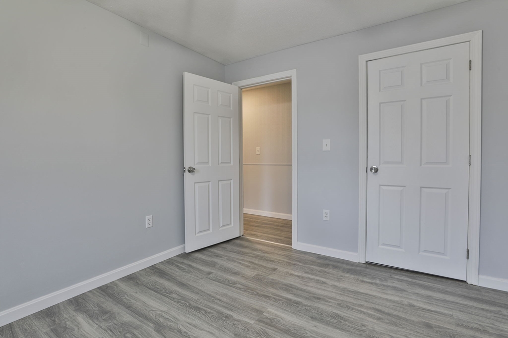 5 Norman Drive, Unit R Derry, NH 03038 - Photo 22 of 28 a view of an empty room with wooden floor