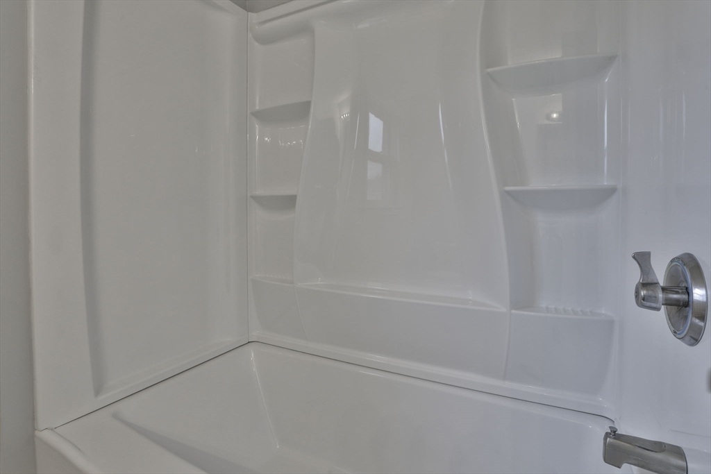 5 Norman Drive, Unit R Derry, NH 03038 - Photo 24 of 28 a bathroom with a bathtub