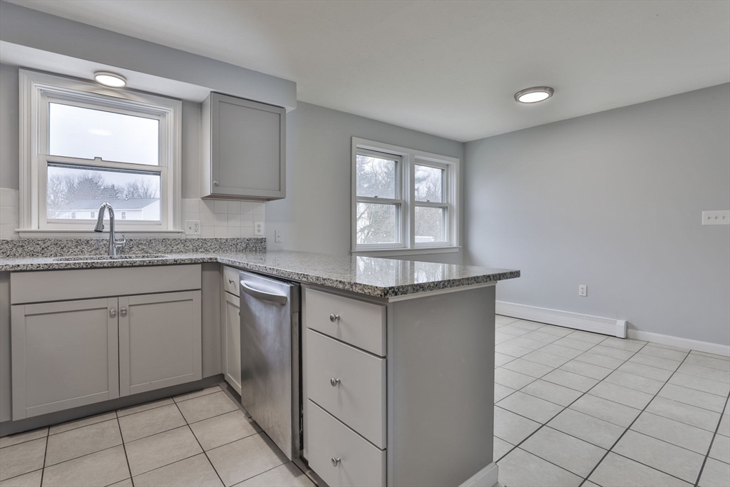 5 Norman Drive, Unit R Derry, NH 03038 - Photo 10 of 28 a kitchen with a sink cabinets and window