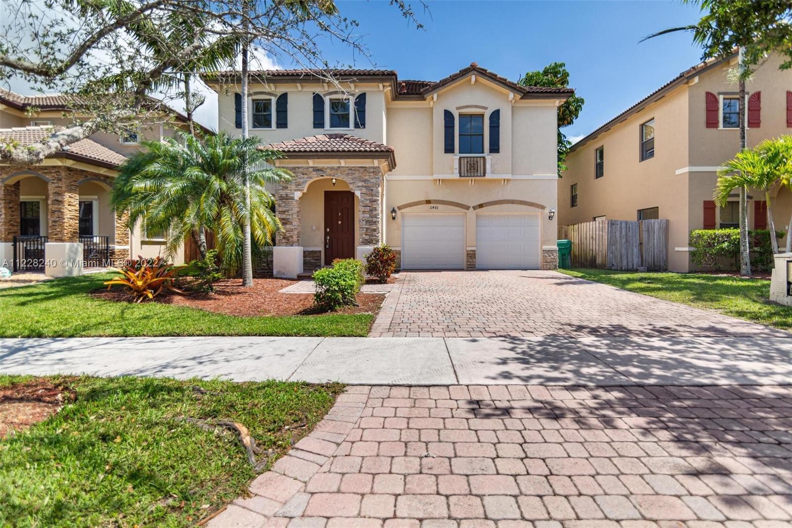 11451 Southwest 243 Terrace Homestead, FL 33032 - Photo 1 of 49 a front view of a house with garden