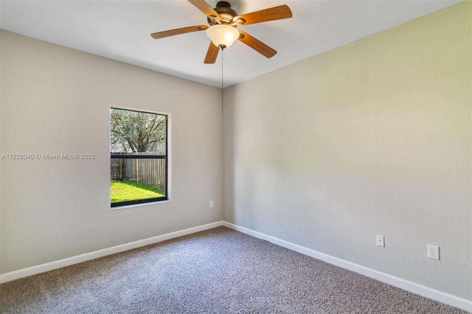 11451 Southwest 243 Terrace Homestead, FL 33032 - Photo 15 of 49 an empty room with a window and a ceiling fan