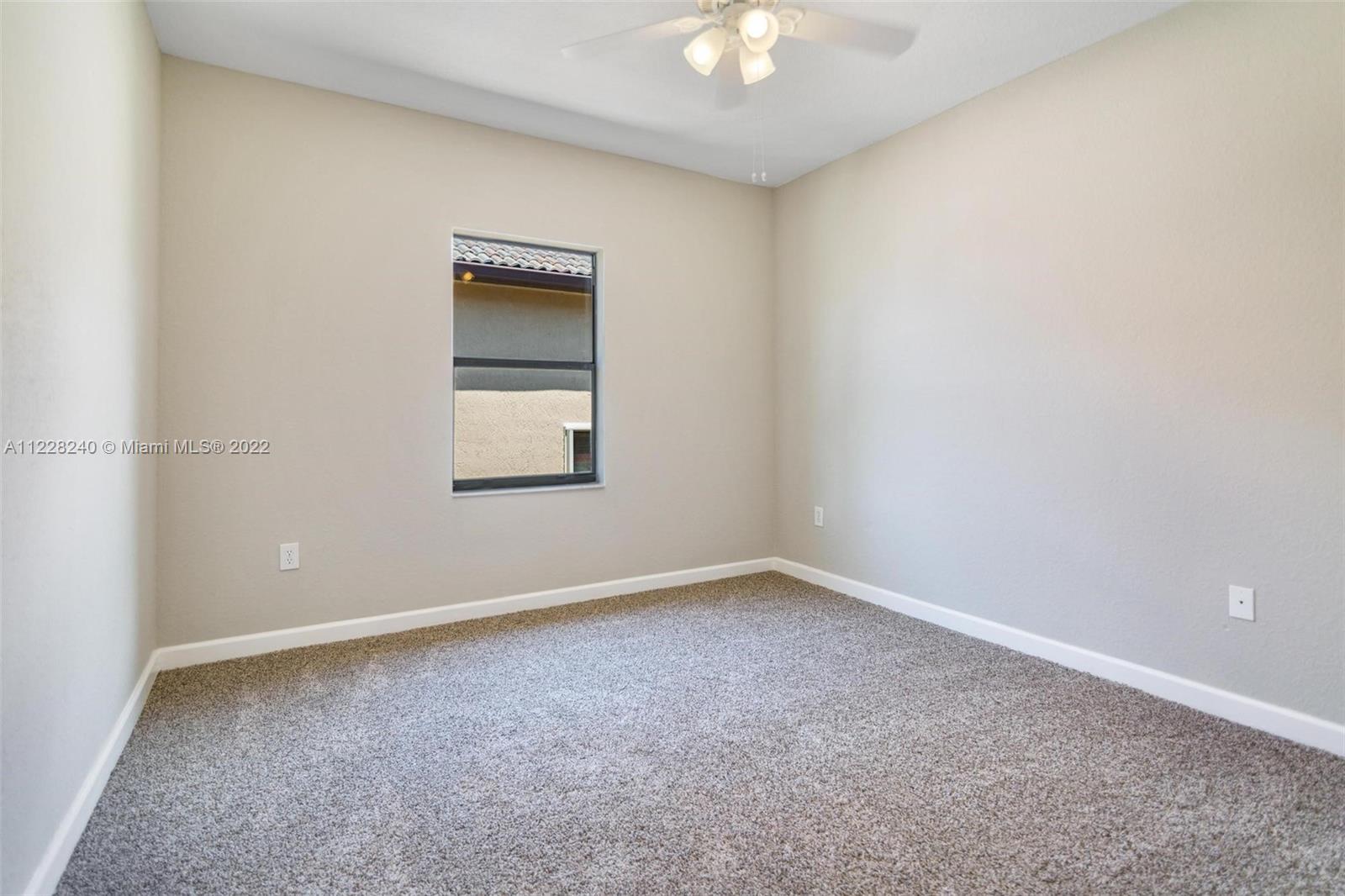 11451 Southwest 243 Terrace Homestead, FL 33032 - Photo 19 of 49 an empty room with a chandelier fan