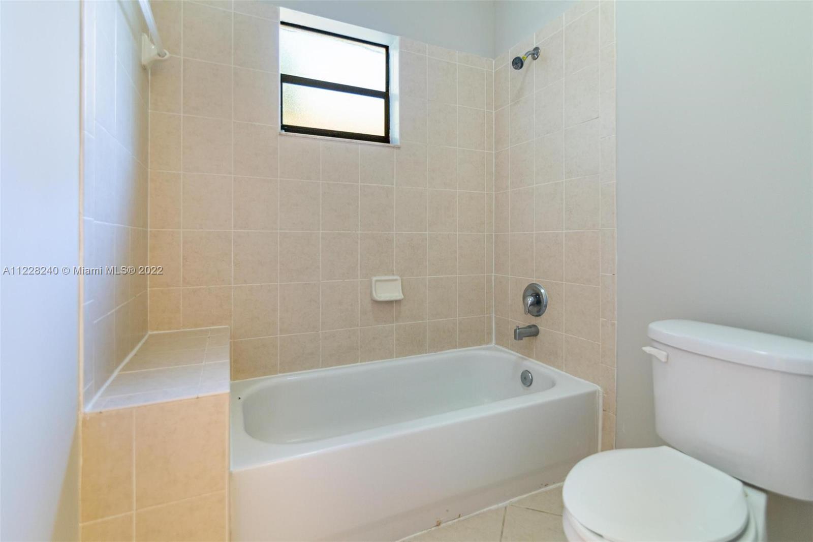 11451 Southwest 243 Terrace Homestead, FL 33032 - Photo 25 of 49 a white bath tub sitting next to a white toilet