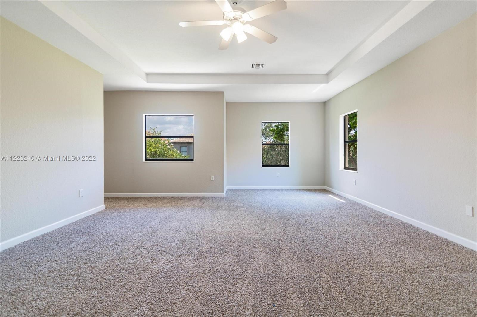 11451 Southwest 243 Terrace Homestead, FL 33032 - Photo 28 of 49 a view of a big room with windows and chandelier fan