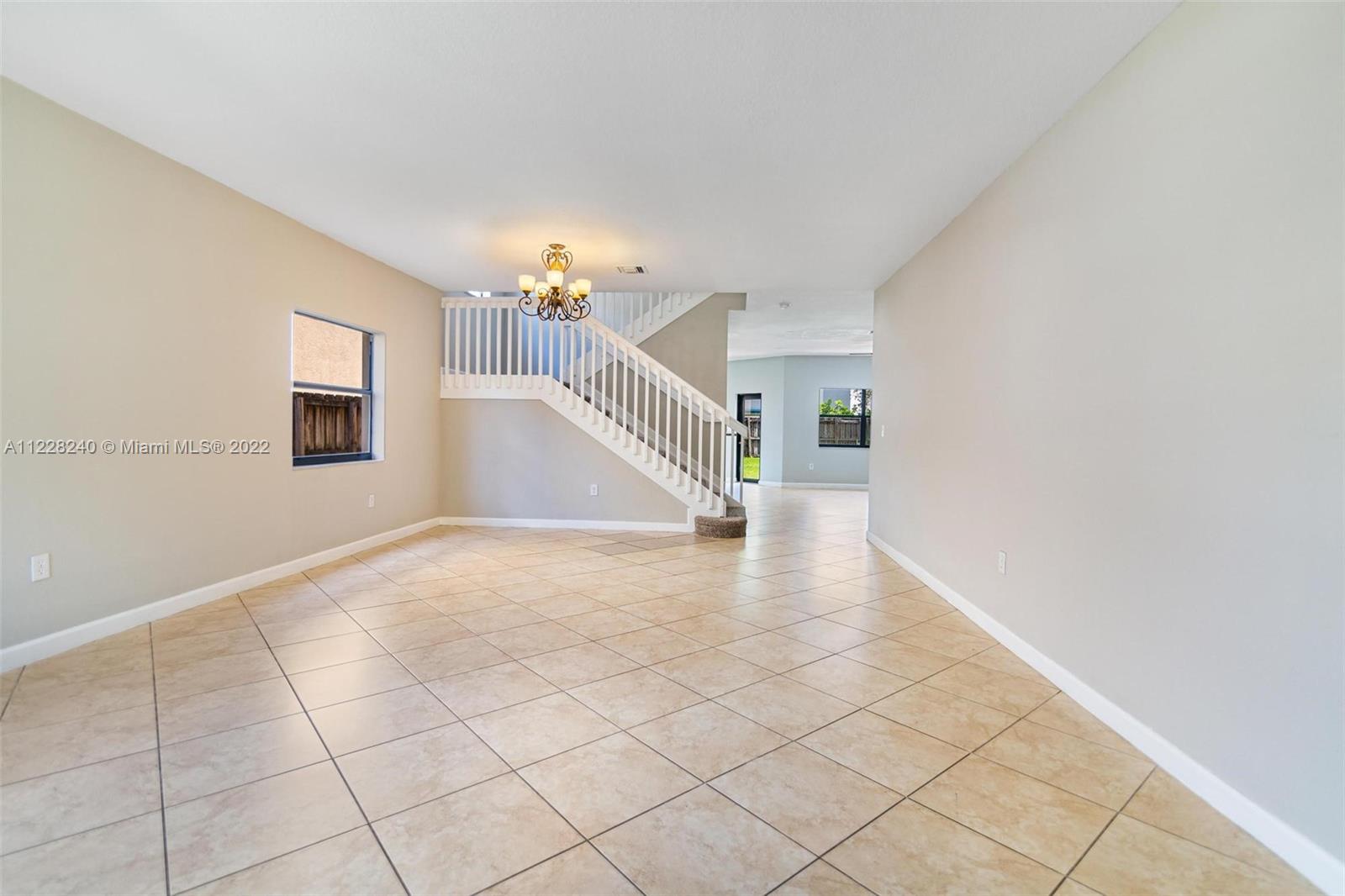 11451 Southwest 243 Terrace Homestead, FL 33032 - Photo 3 of 49 a view of a livingroom with wooden floor and white walls