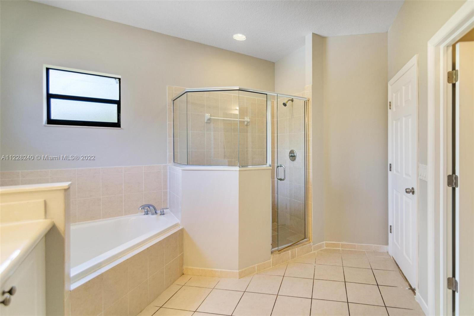 11451 Southwest 243 Terrace Homestead, FL 33032 - Photo 33 of 49 a bathroom with a bathtub and a shower