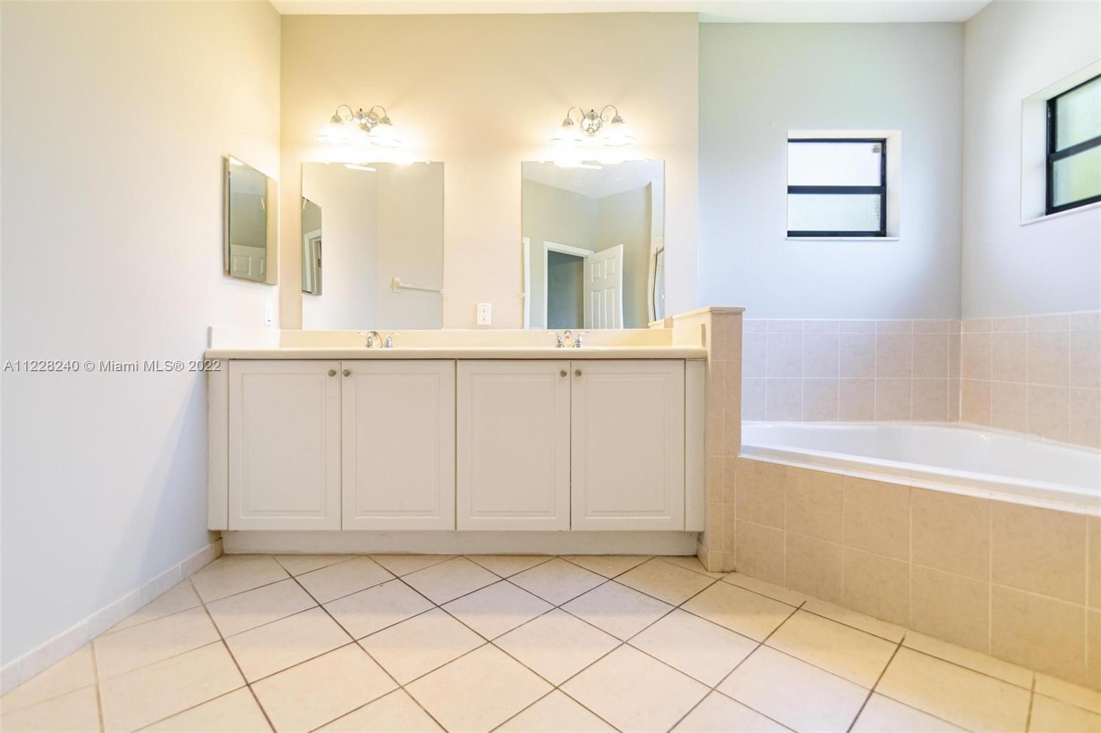 11451 Southwest 243 Terrace Homestead, FL 33032 - Photo 34 of 49 a bathroom with a sink vanity and mirror