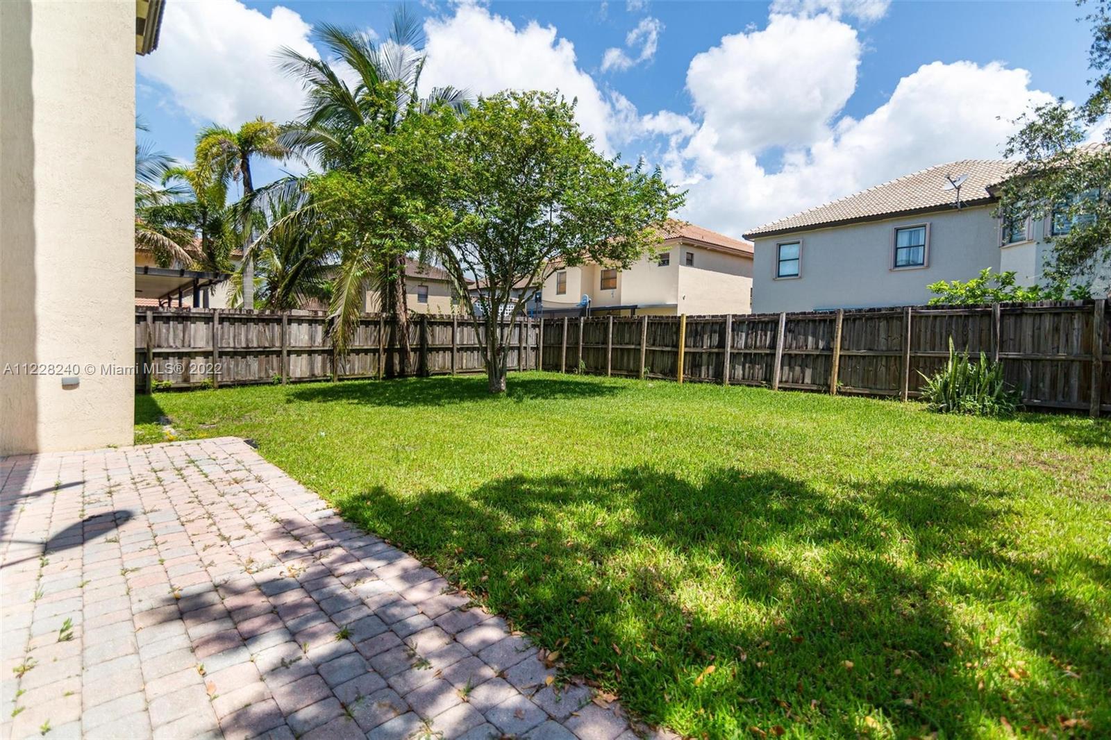 11451 Southwest 243 Terrace Homestead, FL 33032 - Photo 36 of 49 a view of a backyard with a garden and trees