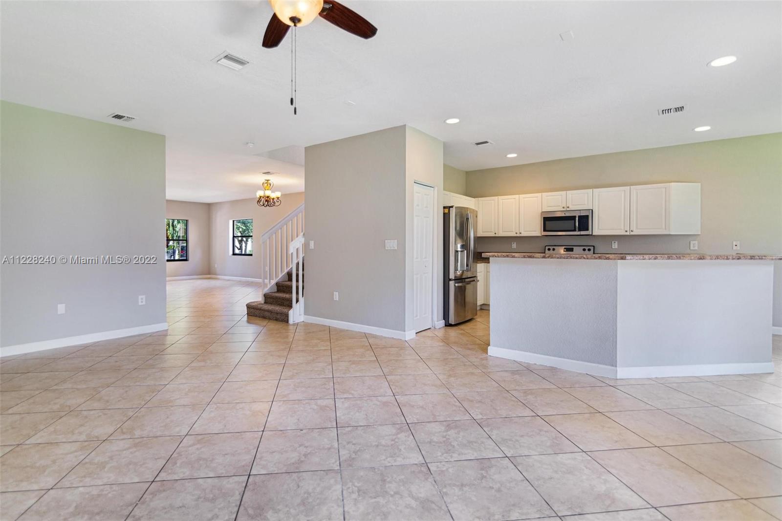 11451 Southwest 243 Terrace Homestead, FL 33032 - Photo 5 of 49 a kitchen with stainless steel appliances granite countertop a refrigerator and a stove top oven
