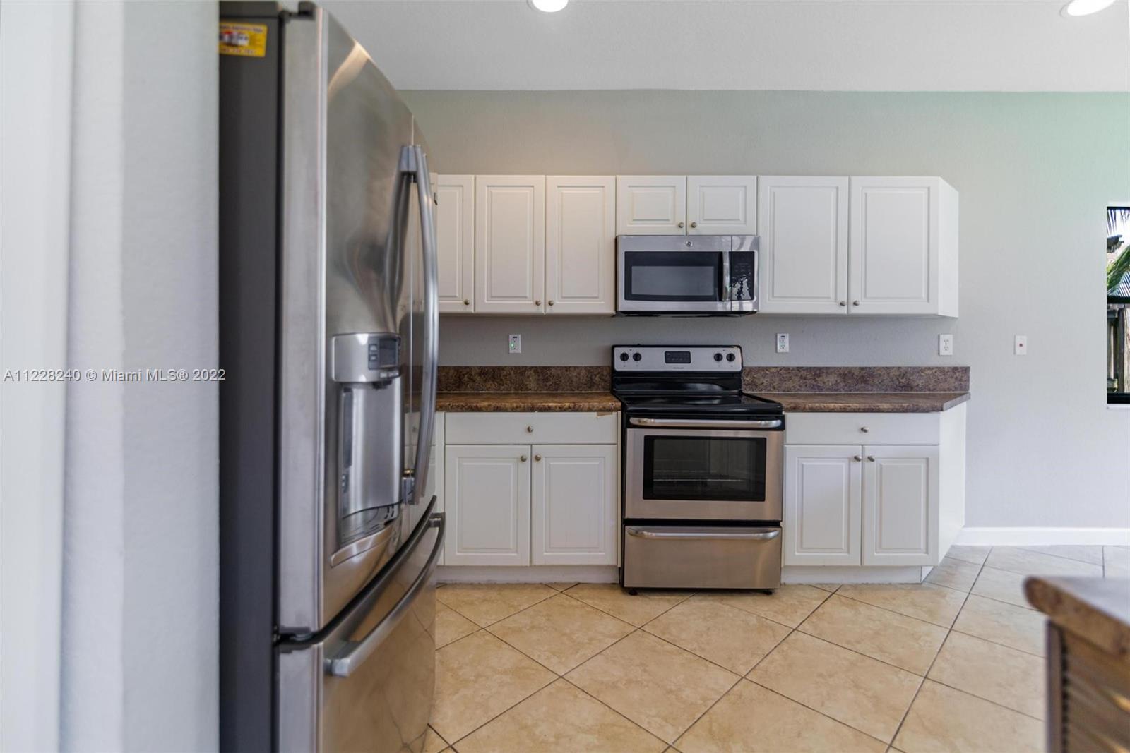 11451 Southwest 243 Terrace Homestead, FL 33032 - Photo 6 of 49 a kitchen with cabinets stainless steel appliances and a counter space