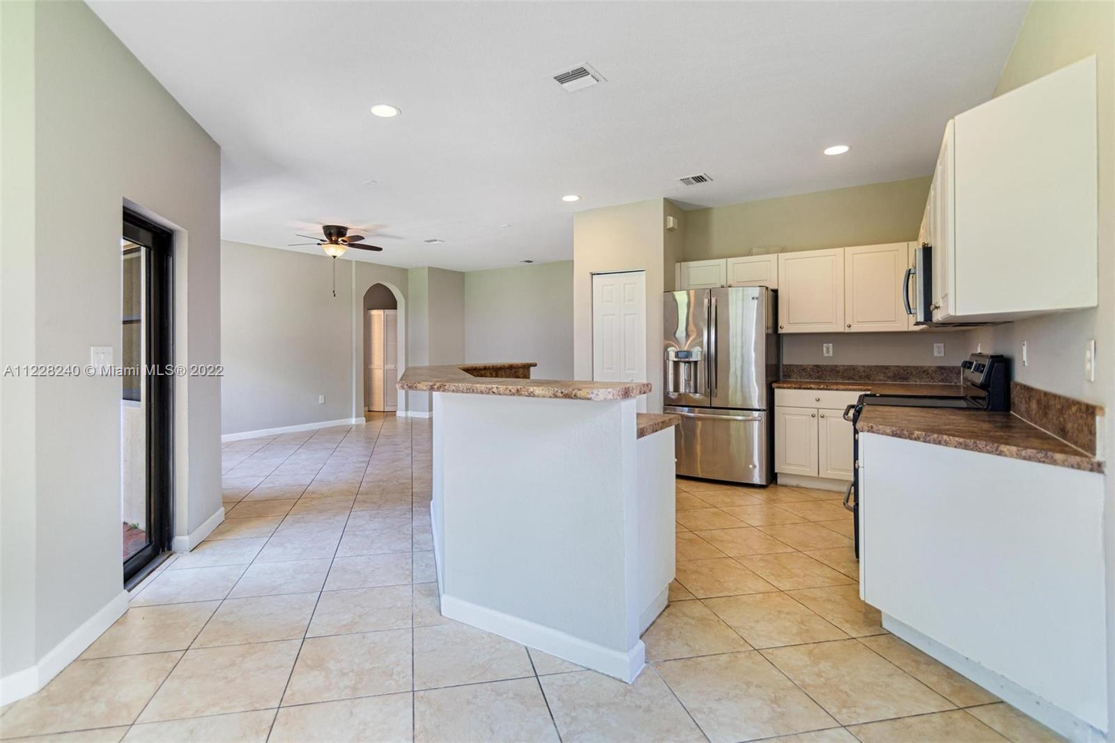 11451 Southwest 243 Terrace Homestead, FL 33032 - Photo 9 of 49 a kitchen with stainless steel appliances granite countertop a refrigerator and a stove