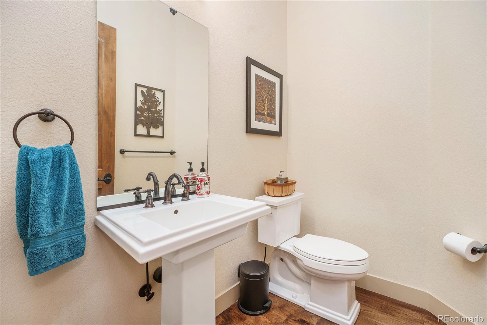 5792 Yank Street Arvada, CO 80002 - Photo 13 of 40 a bathroom with a toilet a sink and mirror