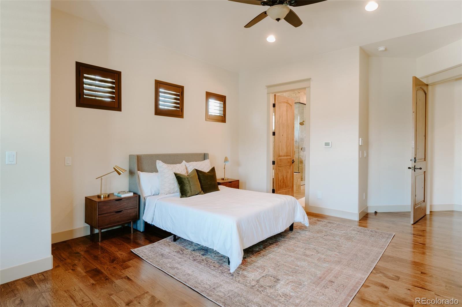 5792 Yank Street Arvada, CO 80002 - Photo 14 of 40 a bedroom with a bed and painting on the wall