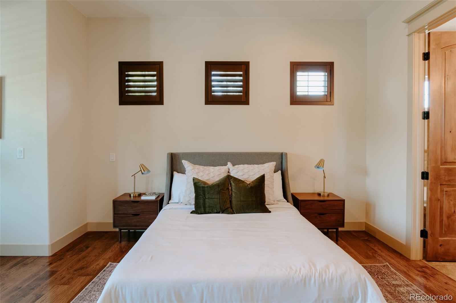 5792 Yank Street Arvada, CO 80002 - Photo 15 of 40 a bedroom with bed and wooden floor