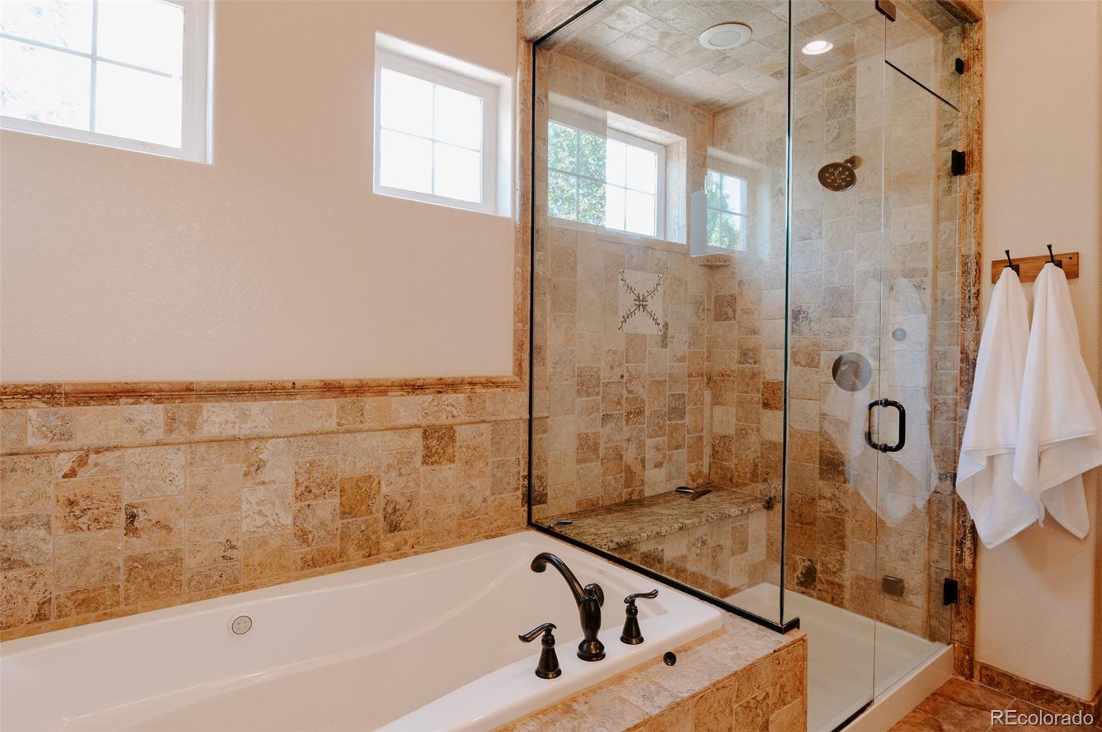 5792 Yank Street Arvada, CO 80002 - Photo 17 of 40 a bathroom with a bathtub and shower