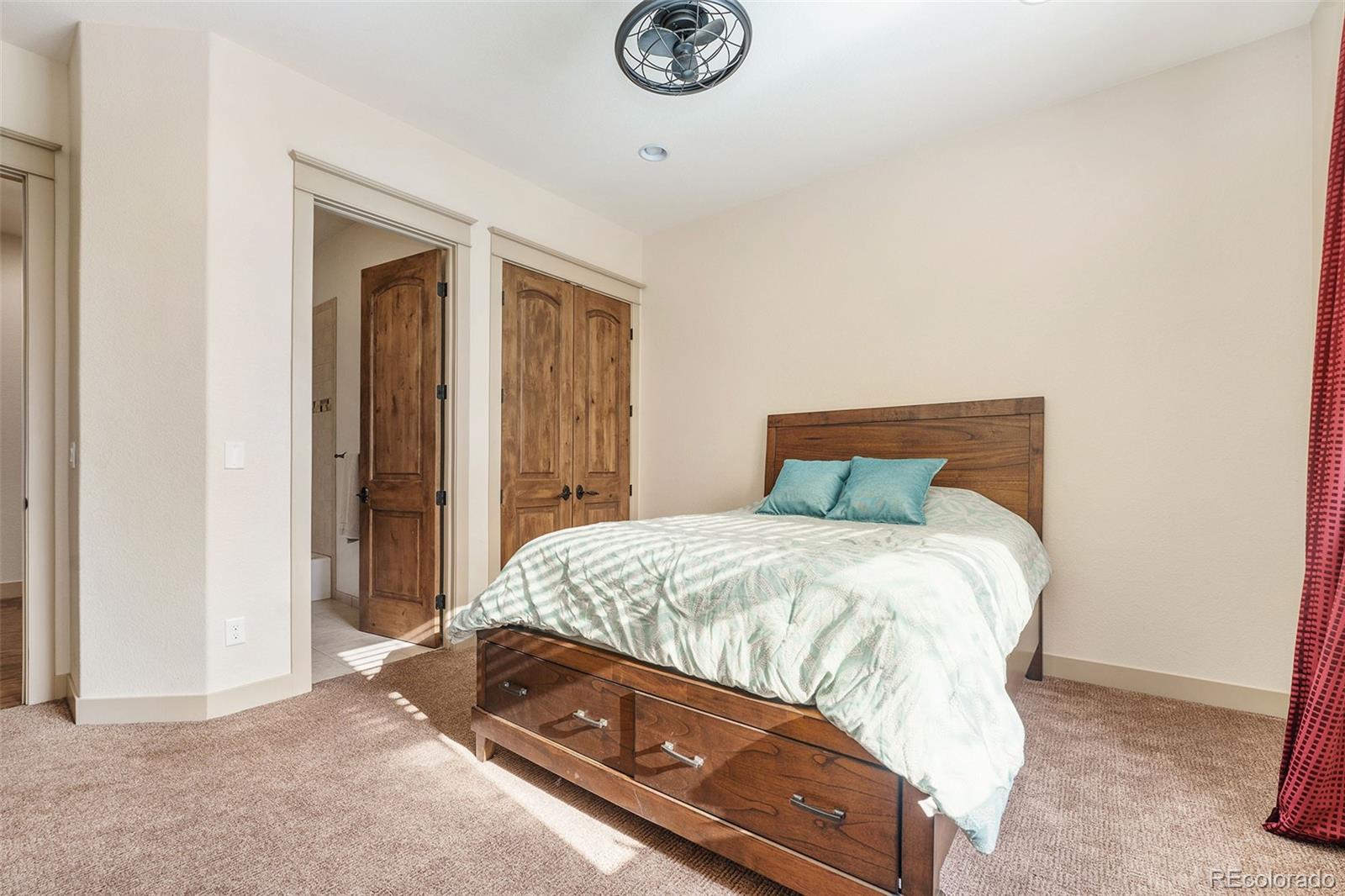 5792 Yank Street Arvada, CO 80002 - Photo 21 of 40 a bedroom with a bed and a chandelier