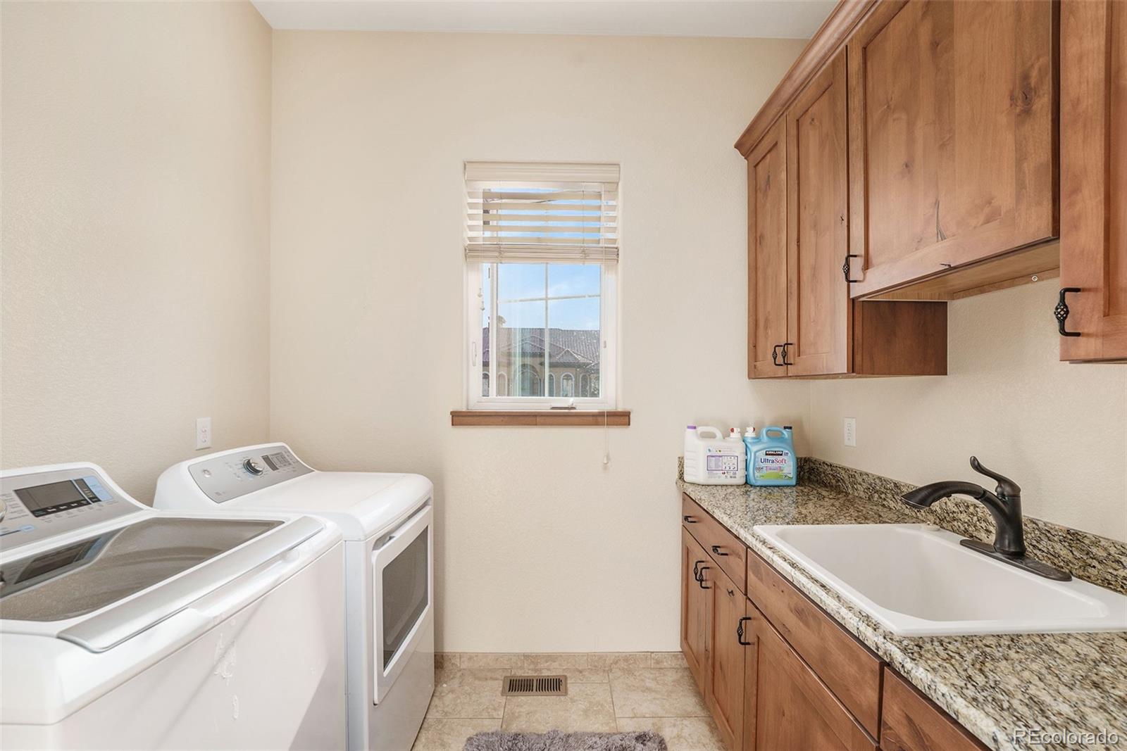 5792 Yank Street Arvada, CO 80002 - Photo 23 of 40 a view of a kitchen with sink and washing machine