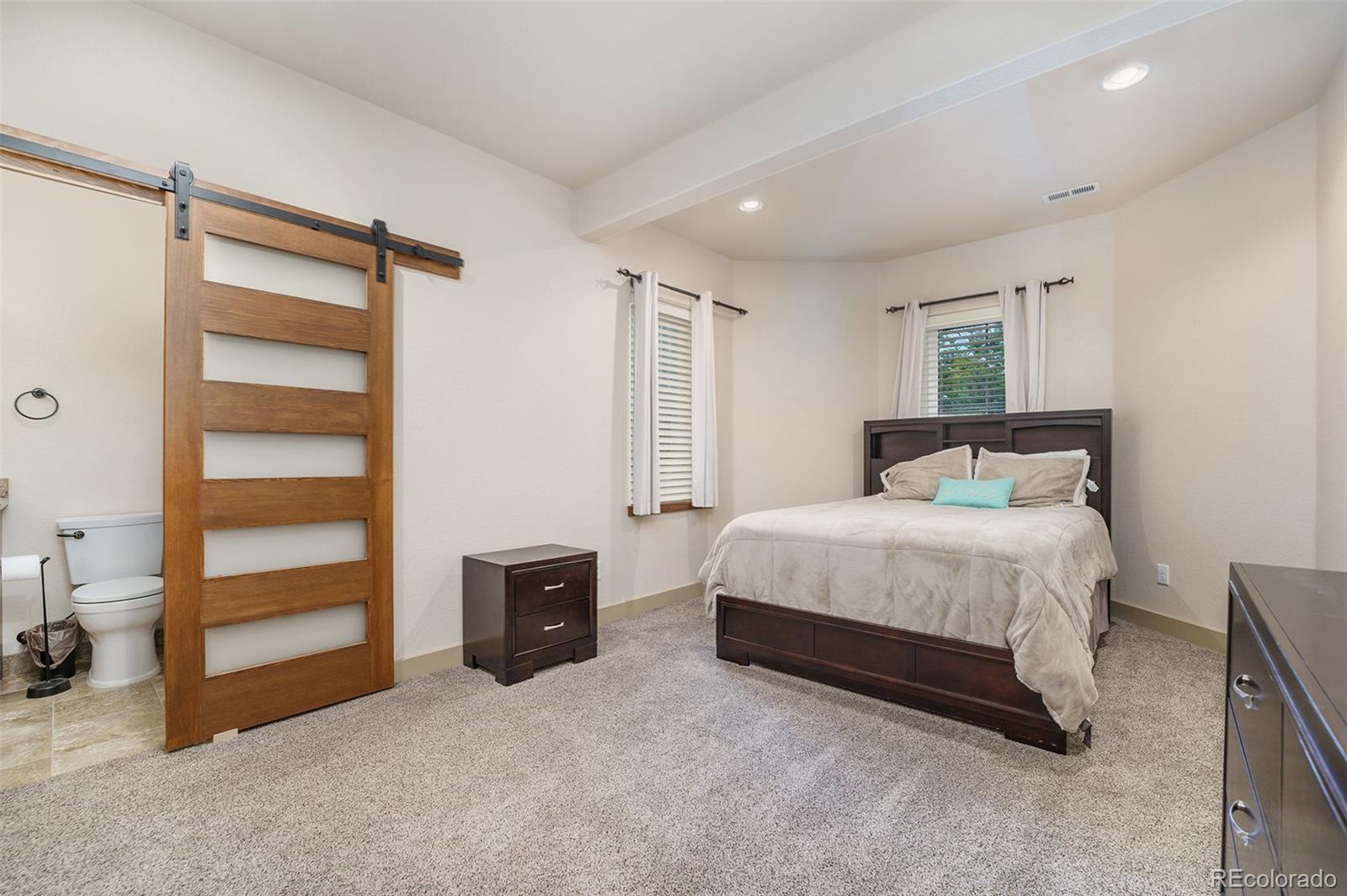 5792 Yank Street Arvada, CO 80002 - Photo 29 of 40 a bedroom with a bed and a dresser