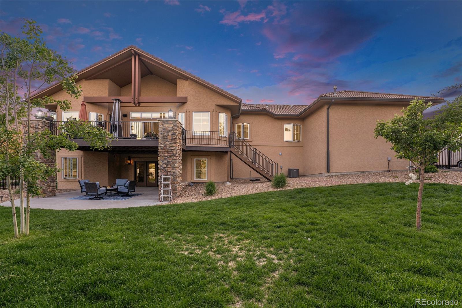 5792 Yank Street Arvada, CO 80002 - Photo 39 of 40 a view of a house with a yard and sitting area