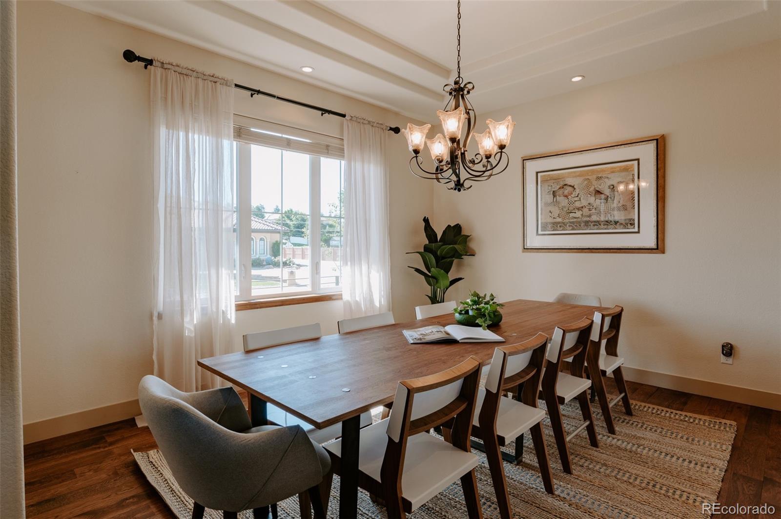 5792 Yank Street Arvada, CO 80002 - Photo 4 of 40 a view of a dining room with furniture window and wooden floor