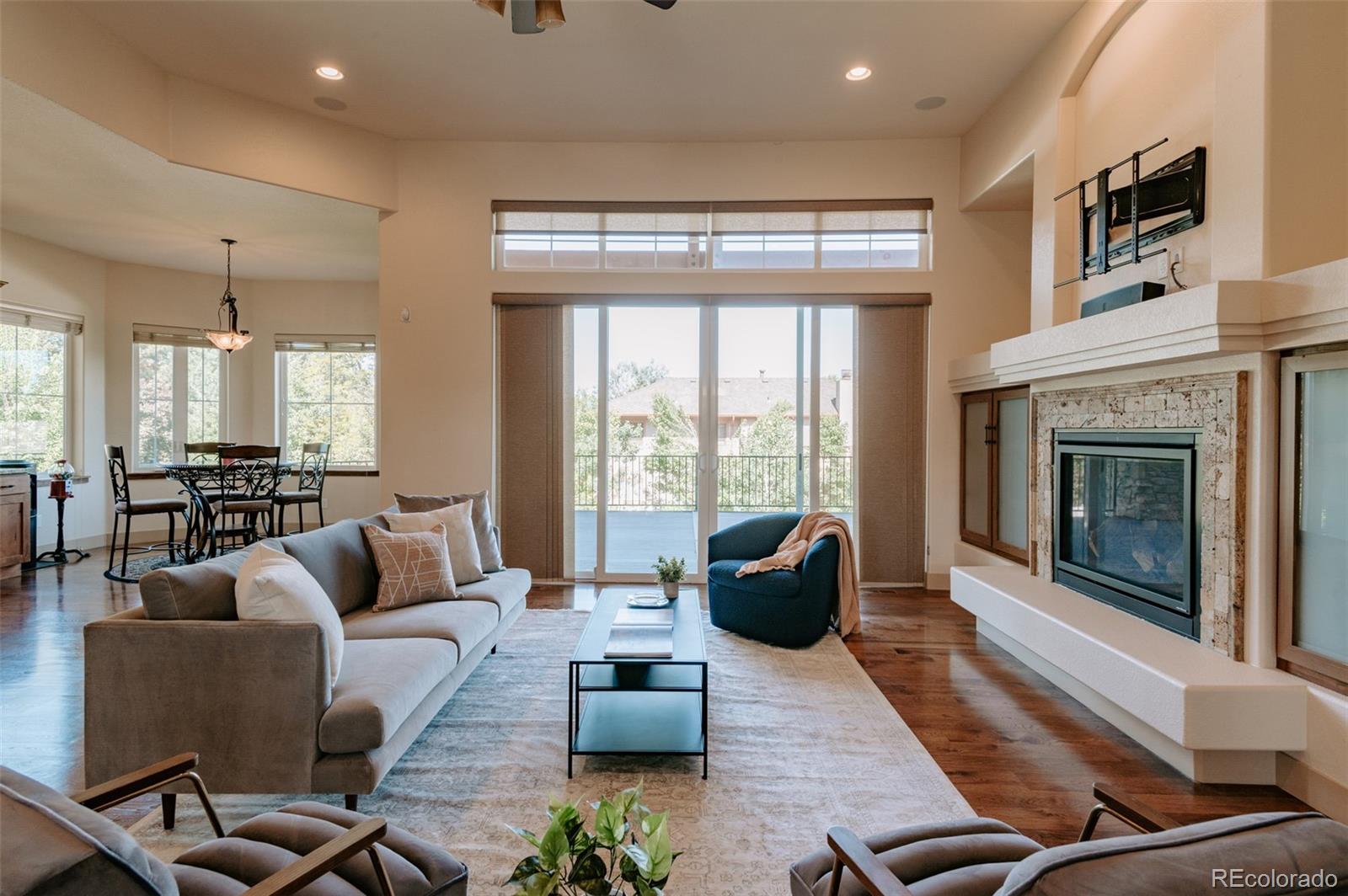 5792 Yank Street Arvada, CO 80002 - Photo 5 of 40 a living room with furniture fireplace and large windows
