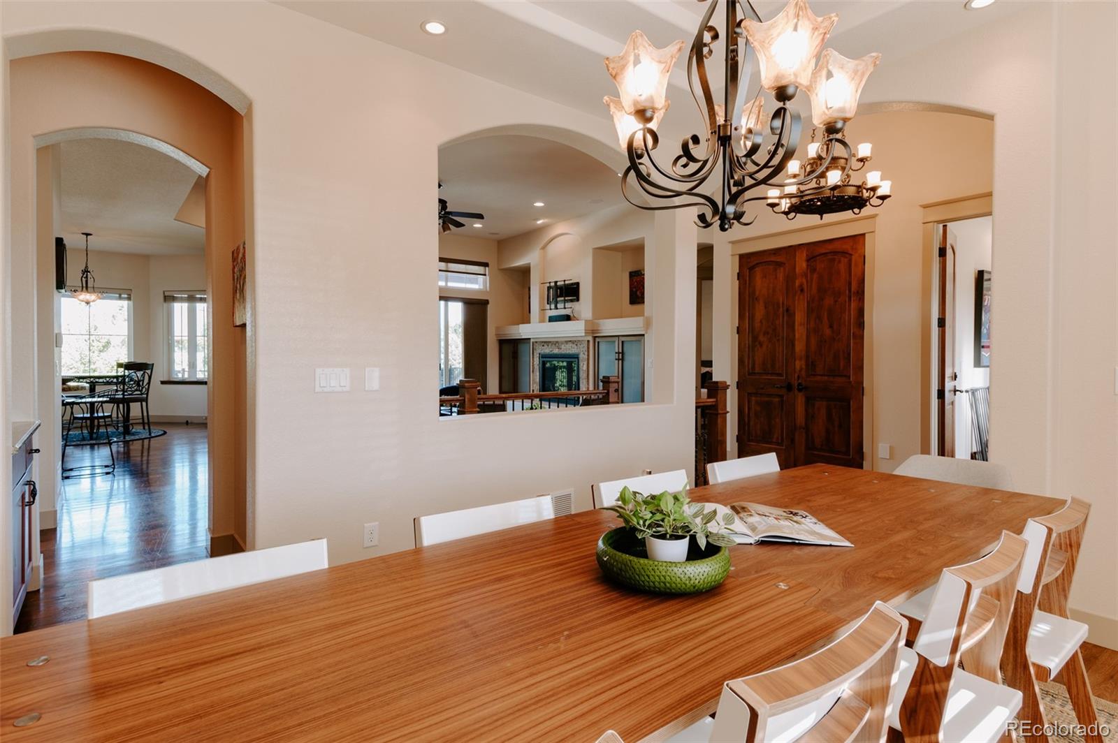 5792 Yank Street Arvada, CO 80002 - Photo 6 of 40 a view of a dining room with furniture and a chandelier