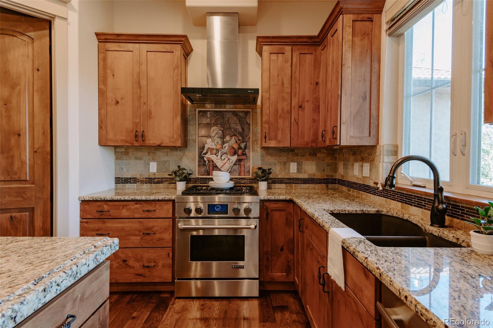 5792 Yank Street Arvada, CO 80002 - Photo 10 of 40 a kitchen with a stove and a sink
