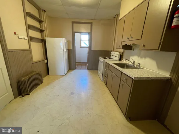 a kitchen with cabinets appliances and a sink