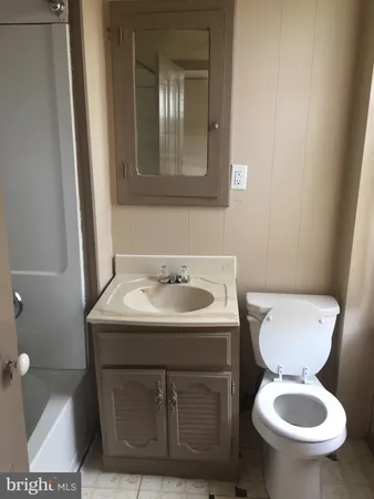 a kitchen with a refrigerator and a stove top oven