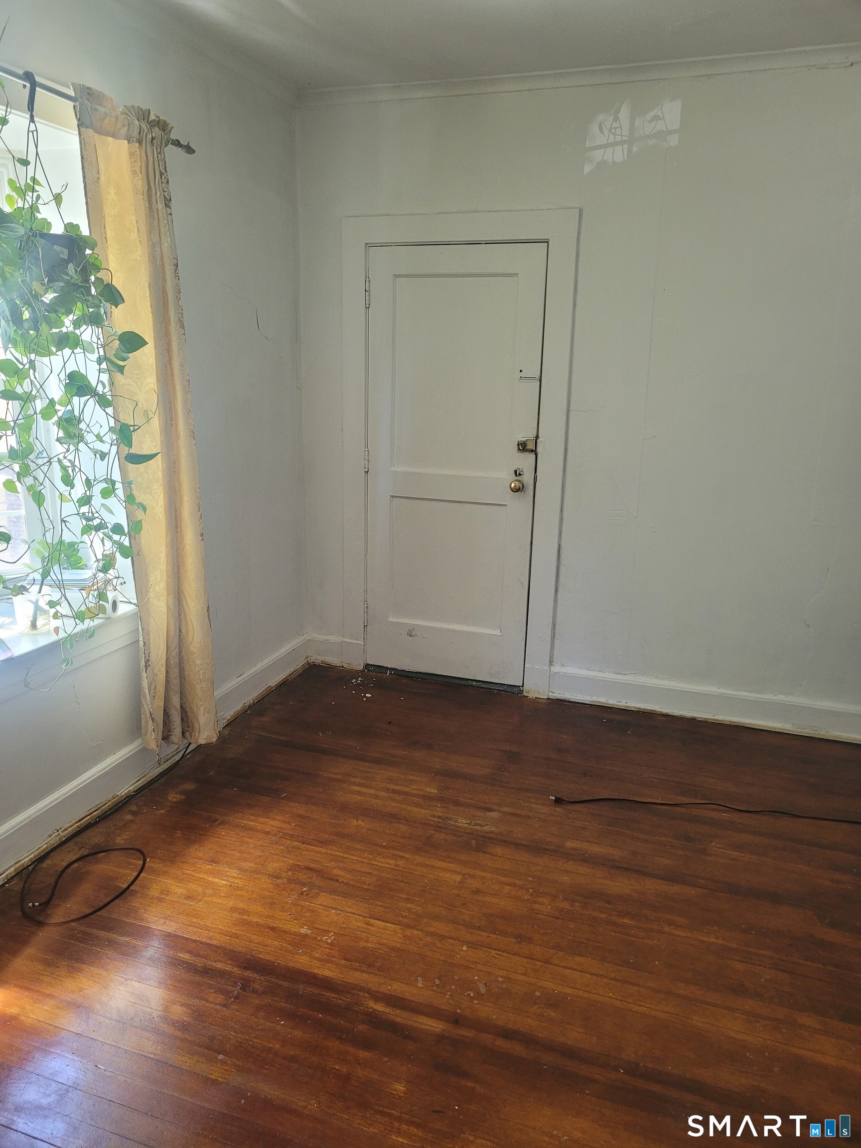 606 Wilmot Avenue, Unit 4 Bridgeport, CT 06607 - Photo 4 of 16 a view of empty room with wooden floor and fan