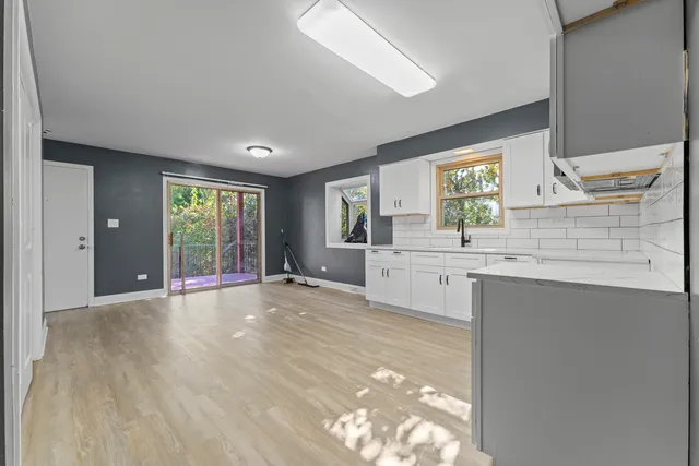 a view of a kitchen with a sink dishwasher and wooden floor