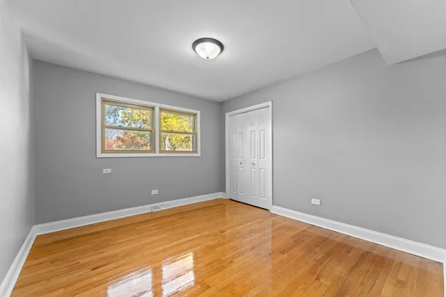 a view of a room with wooden floor and windows