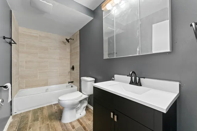 a bathroom with a sink toilet and shower