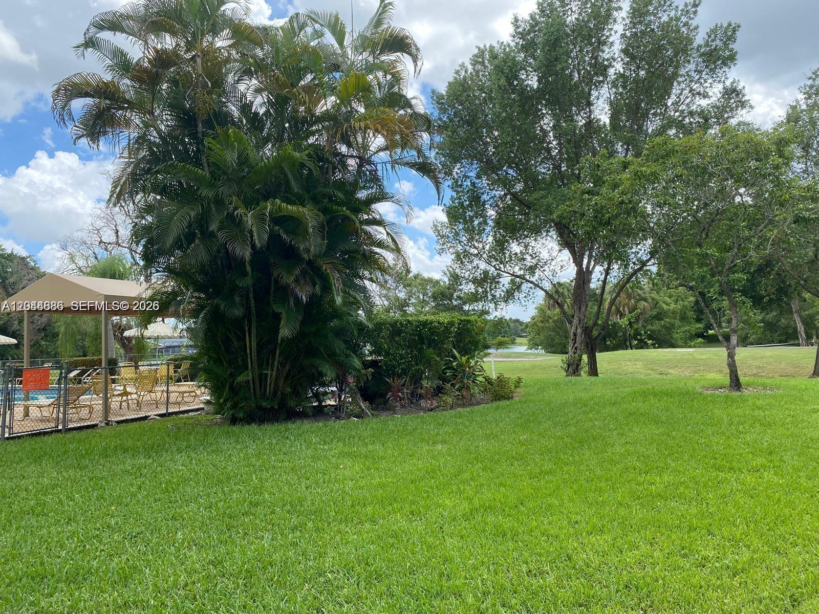 8838 West McNab Road, Unit 104 Tamarac, FL 33321 - Photo 19 of 23 a view of a park with a tree