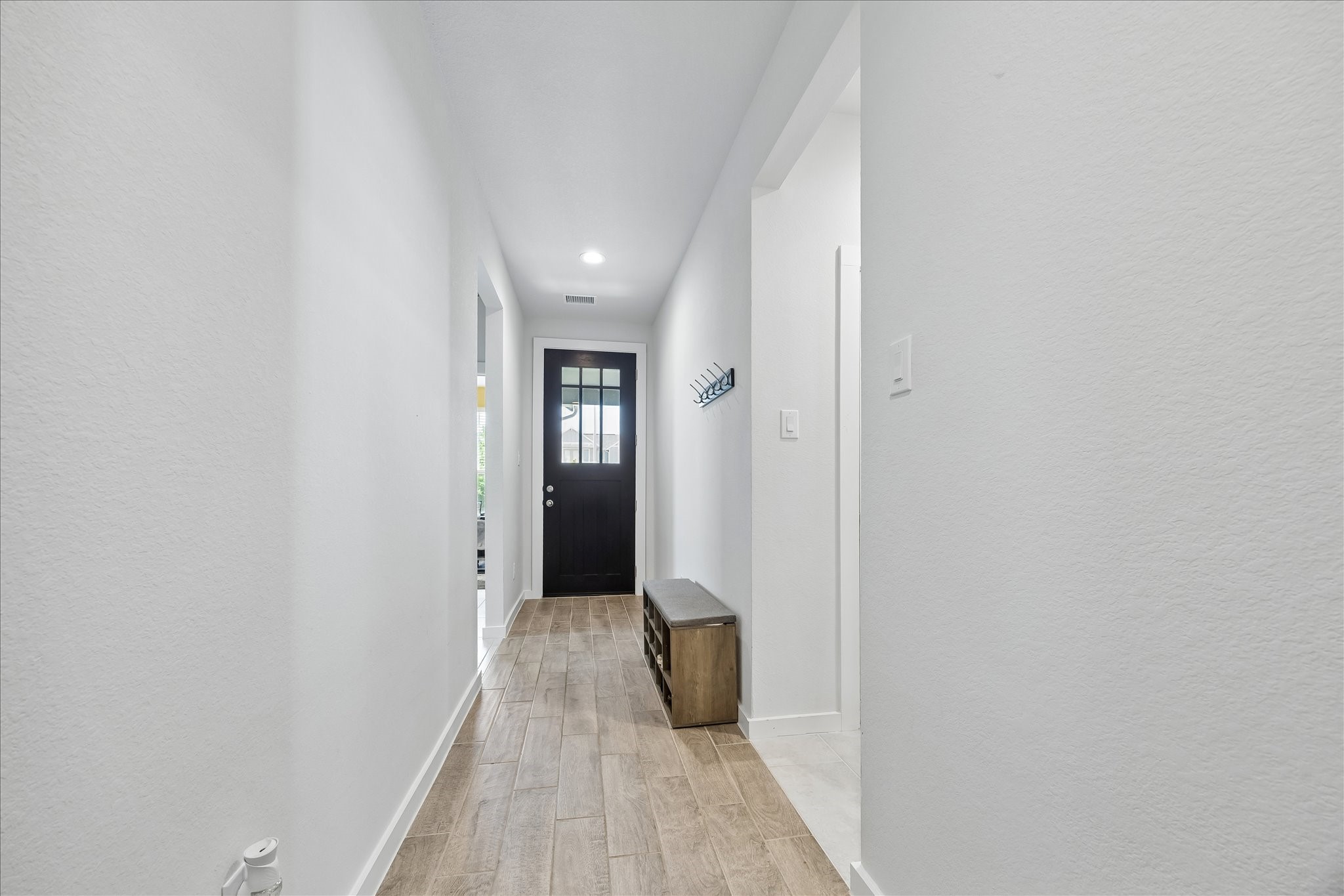 33002 Carolyns Perfection Loop Fulshear, TX 77441 - Photo 7 of 29 a view of a hallway with wooden floor and a bathroom