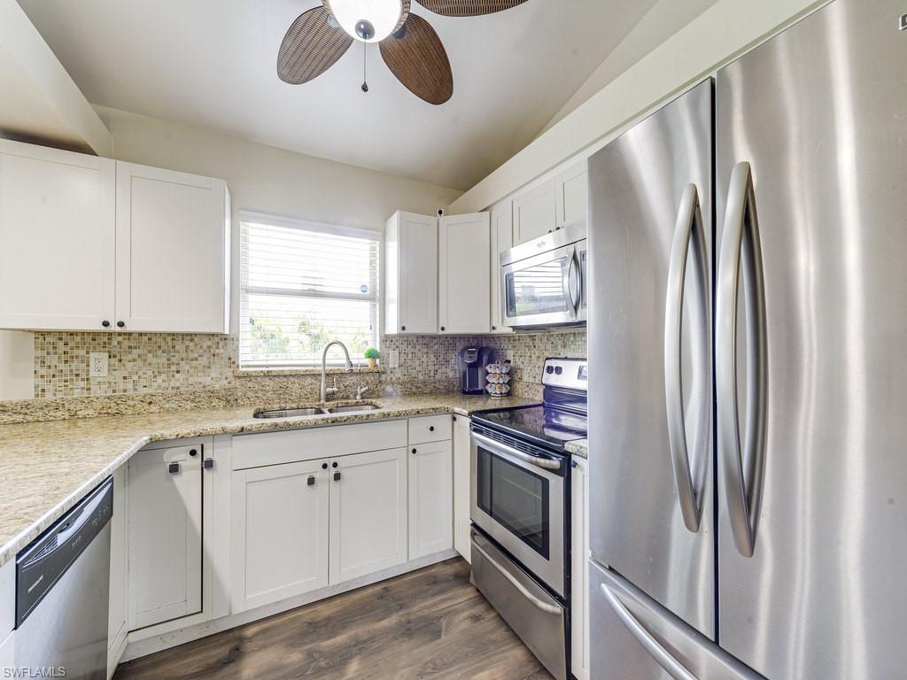 8453 Butternut Road Fort Myers, FL 33967 - Photo 6 of 15 a kitchen with stainless steel appliances granite countertop a refrigerator sink and stove