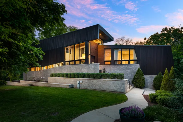 a front view of a house with a garden