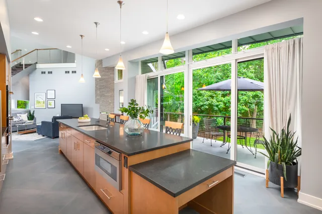 a dining room with furniture and a floor to ceiling window