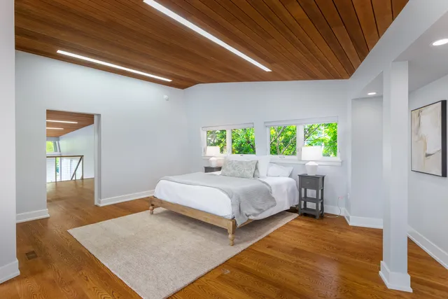 an aerial view of residential house with outdoor space and trees all around