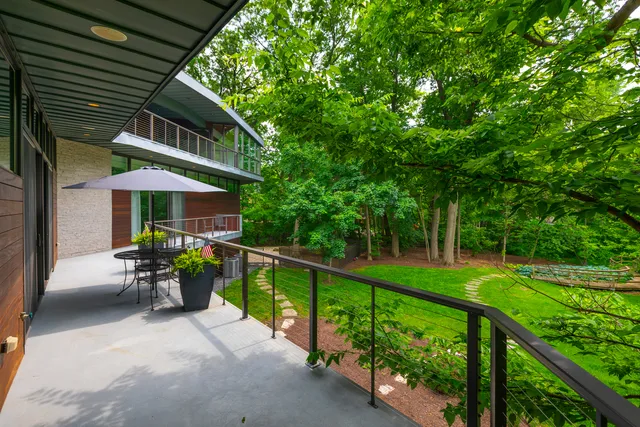 an aerial view of house with yard swimming pool and outdoor seating
