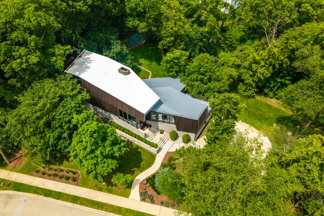 a front view of a house with a yard table and chairs