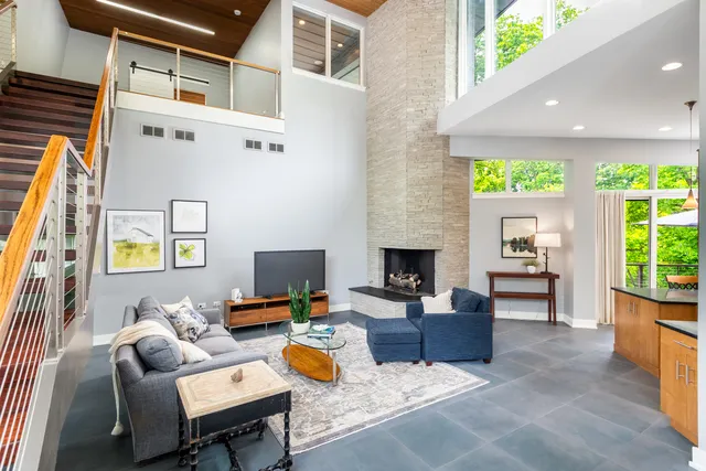 a kitchen with stainless steel appliances granite countertop table chairs stove and refrigerator