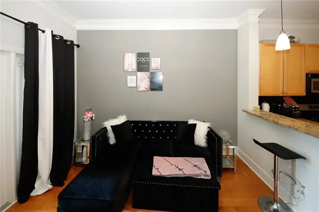 a living room with furniture and wooden floor